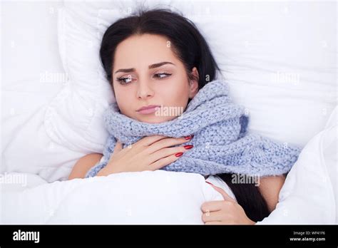 Sick Young Woman Is Coughing On The Bed Stock Photo Alamy