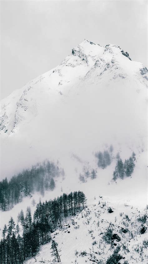 Download Wallpaper 2160x3840 Mountain Peak Snowy Slope Winter