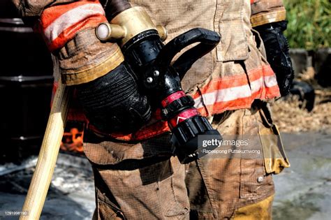Firefighter Holding Fire Hose Fire Prevention And Extinguishing Concept