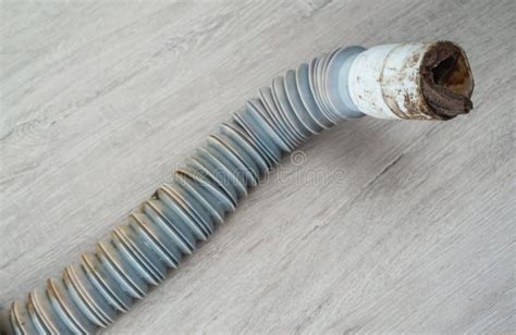 Clogged Plastic Corrugated Drain Pipe Lies On The Floor Stock Photo