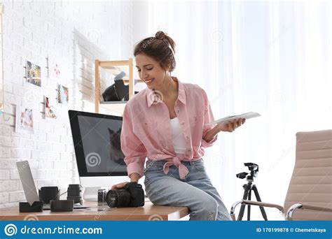Professional Photographer With Camera Working In Modern Office Stock