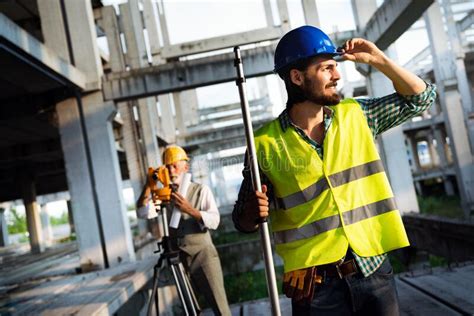 Portrait Of Construction Architects Engineers Working On Building Site