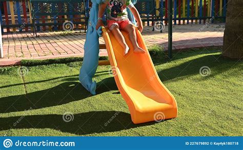 The Child Slides Down The Children S Slide Stock Photo Image Of