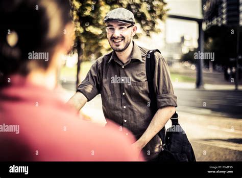 Two Men Talking To Each Other At Park In Berlin Hi Res Stock