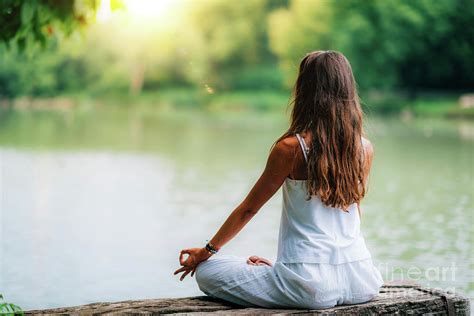 Woman Meditating By A Lake Photograph By Microgen Imagesscience Photo