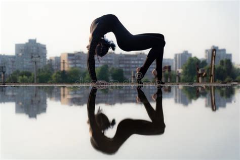 Silhouette Of Flexible And Fit Girl Bending Her Back Concept Of Yoga