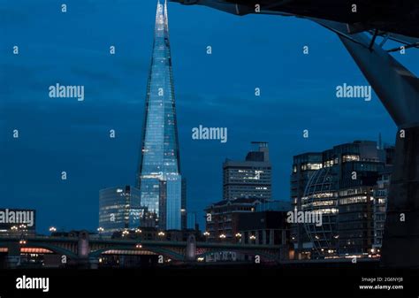 The Shard In Central London At Dusk Reflecting In The Thames River