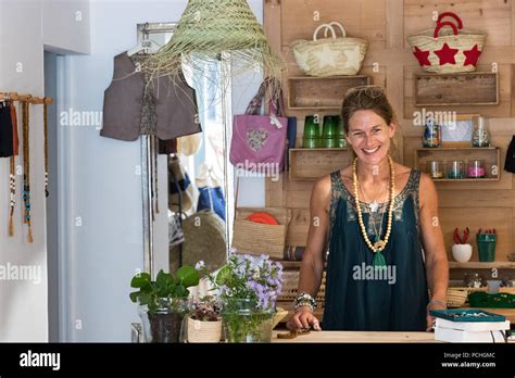 Portrait Of French Blonde Mature Woman Smiling In Her Handmade Ts Store In France