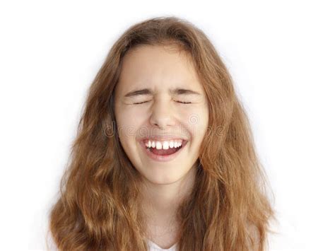 pretty teenager girl with long hair makes very funny face and laughing with closed eyes stock