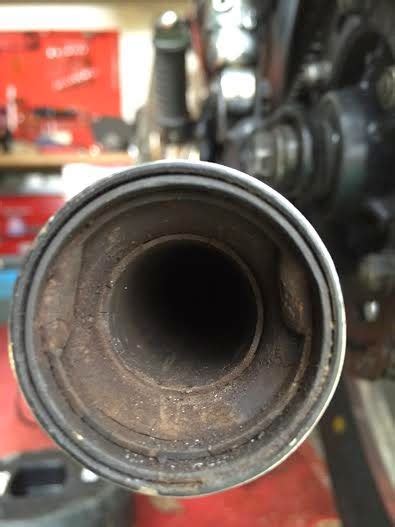 You'll need to remove the hex bolt. W650 exhaust baffle removal