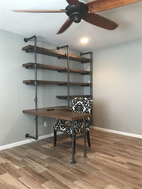 Shelving Wall Unit With Built In Desk Made Using Galvanized Piping For