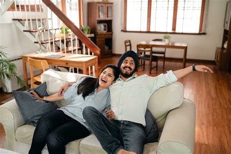 Delighted Ethnic Couple Having Fun On Sofa In Cozy Apartment · Free
