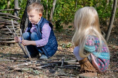 Two Young Children Playing With Sticks Outdoors — Stock Photo © Ampack