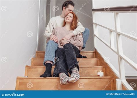 Tender Hugs Of Lovers On Wooden Stairs Red Haired Young Woman In