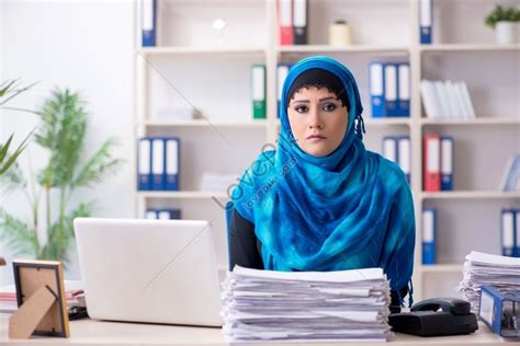 photo of a female employee wearing a hijab working in an office picture and hd photos free