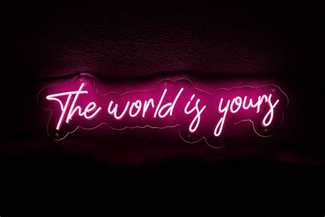 A Neon Sign That Says The World Is Yours
