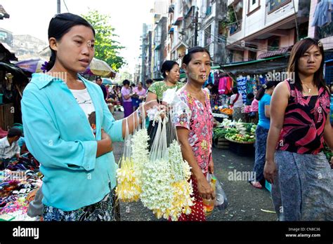 A Young Burmese Girl Sells Jasmine Flower Garlands In A Street Market