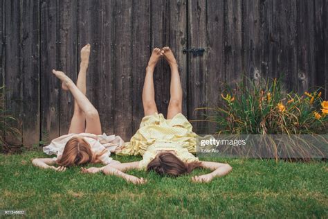 Two Sisters Lying On The Grass Photo Getty Images