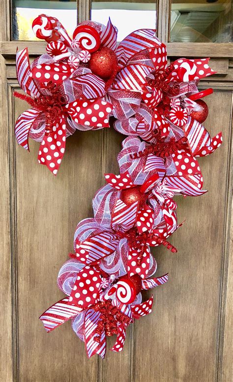 These would be fun for a kids table at a holiday dinner or a sweet way to spruce up the coffee/tea station after dinner. Candy Cane Door Hanger, Candy Cane Wreath, Candy Cane ...