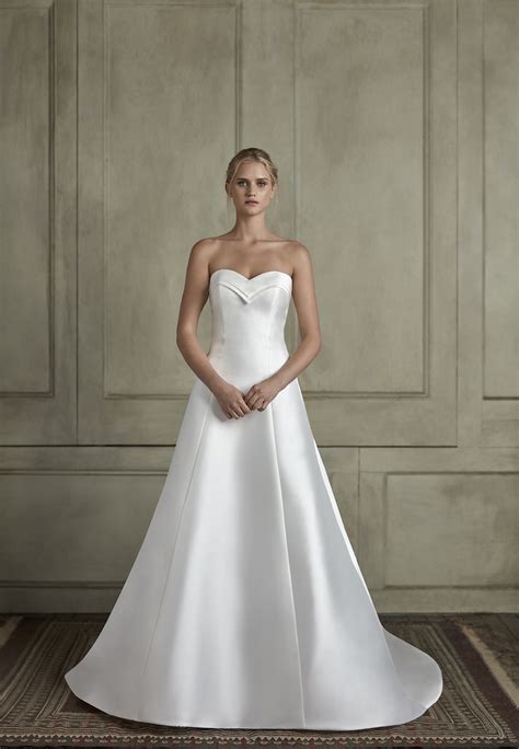 A fit and flare silhouette hugs the body and flares off just below the hips, accentuating the waist, or at the knees beautifully showing off your body. Strapless Sweetheart Fit And Flare Wedding Dress | Kleinfeld Bridal