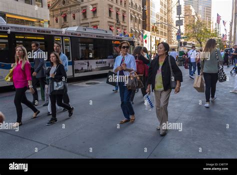 New York Ny Usa Crowd Of People Walking On Sidewalk Shopping