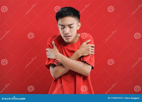 Young Asian Man Feel Dizzy And Feverish Isolated On Red Stock Photo