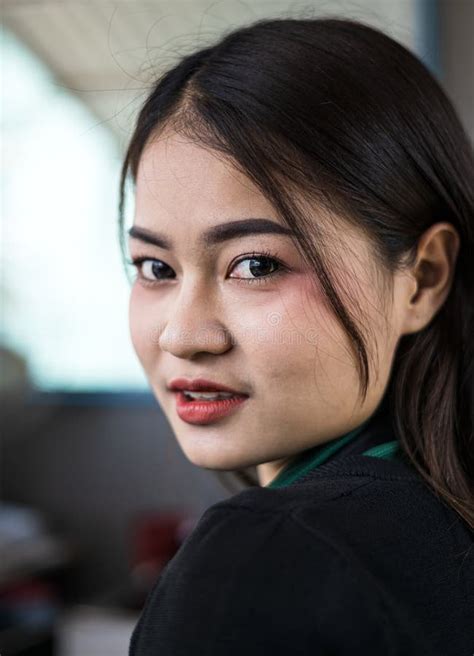 A Close Up Of A Portrait Of A Beautiful Thai Woman Smiling Seductively Inside Her Coffee Shop