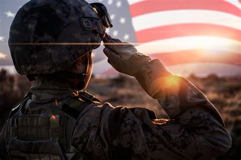 Female Solider Saluting Us Flag At Sunrise Stock Photo Download Image