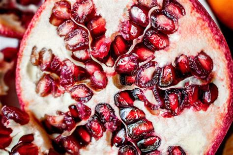 Pomegranate Fruit Cut In Half Up Close On Seeds Inside Stock Photo
