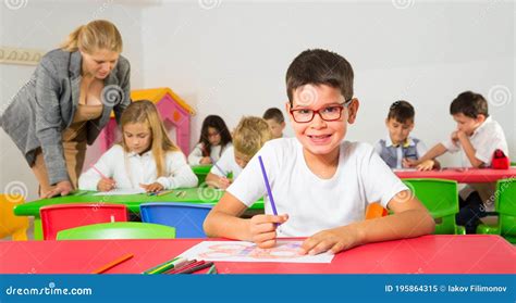 Little Schoolboy Drawing With Color Pencils Stock Image Image Of