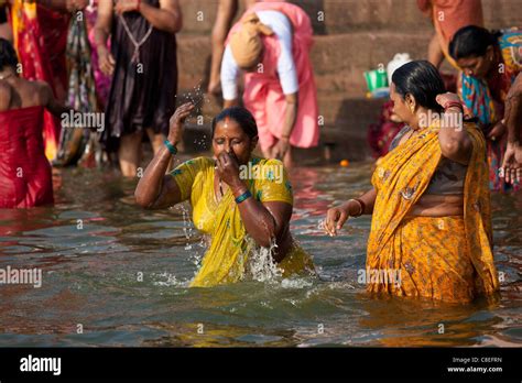 Indian Hindu Pilgrims Bathing In The Ganges River At Dashashwamedh Ghat