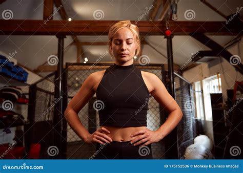 Portrait Of Female Mixed Martial Arts Fighter Training In Gym Stock
