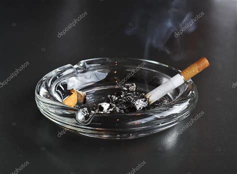 Lit Cigarette In The Ashtray — Stock Photo © Photostella 113778990