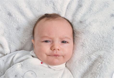 Baby 2 Months Old The Baby Is Lying On A White Blanket The Baby Is