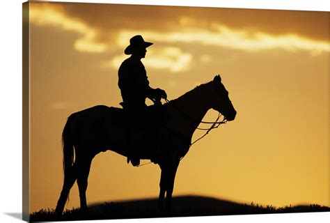 Silhouette Of Cowboy On Horseback At Sunset Or Sunrise Wall Art Canvas