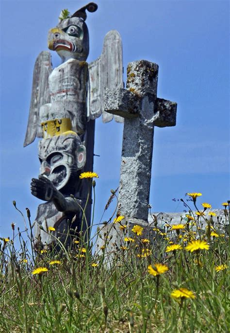 first nations culture totem poles intermingle with crosses in alert bay s cemetery alert bay