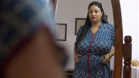 Indian Overweight Woman Pinching Her Belly Fat With Frowning G