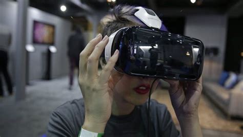 A Woman Demonstrates The Oculus Virtual Reality Headset At The Facebook