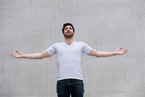 Man With Arms Outstretched Stock Photo Dissolve