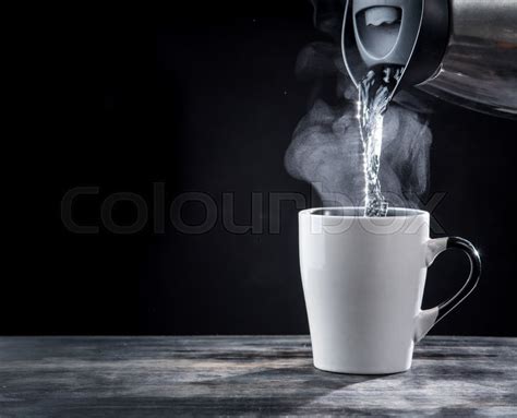 Pouring Hot Water Into Into A Cup On A Stock Image Colourbox