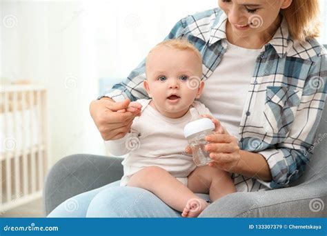 Lovely Mother Giving Her Baby Drink From Bottle Stock Image Image Of