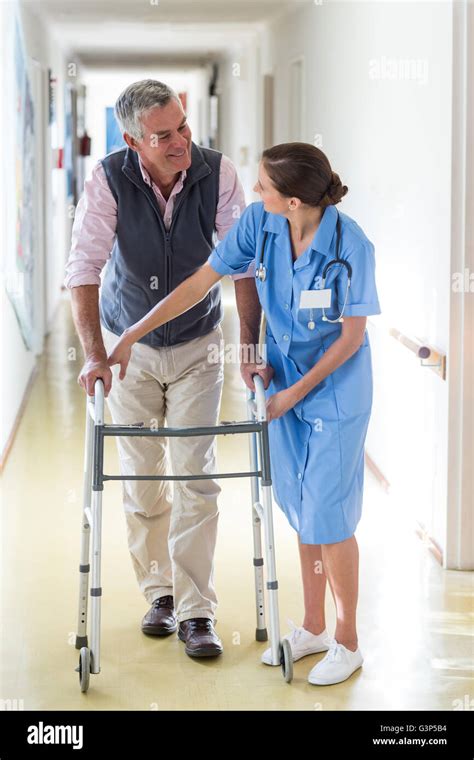 Nurse Helping Senior Patient To Walk With Walking Frame Stock Photo Alamy