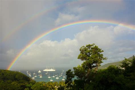 A Vibrant Double Rainbow Over A Caribbean Harbor Stock Image Image Of