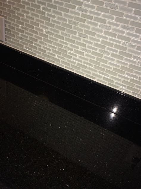 Maybe you would like to learn more about one of these? Black Galaxy granite and white glass backsplash kitchen ...