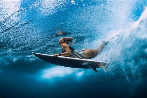 Surfgirl With Surfboard Dive Underwater With Under Ocean Wave Stock