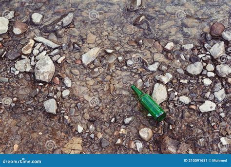 Glass Bottle Thrownon The River People Left Trash On The River Bank