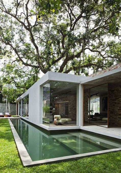 A Minimalist Outdoor Space With A Green Lawn A Long And Narrow Pool