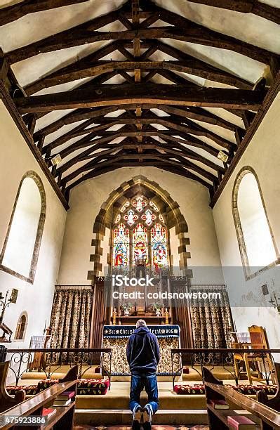 Young Man Kneeling At The Altar In Church Stock Photo Download Image
