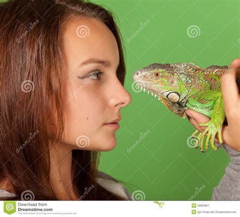 A Young Girl Stares At Iguana Royalty Free Stock