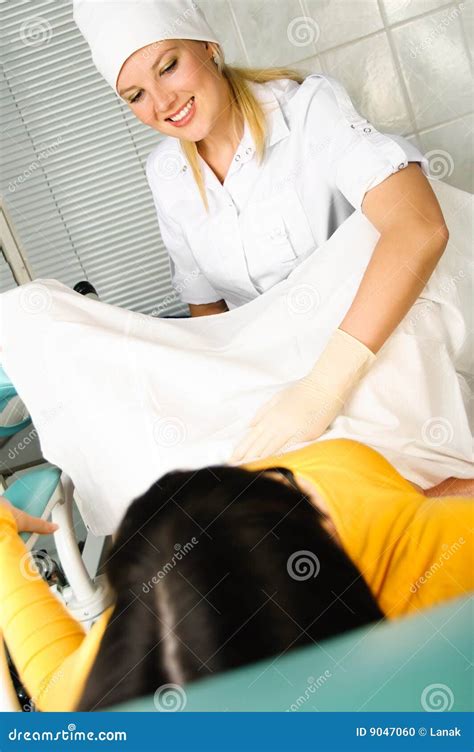 gynecologist examining and performing pelvic floor treatment on pregnant caucasian woman stock